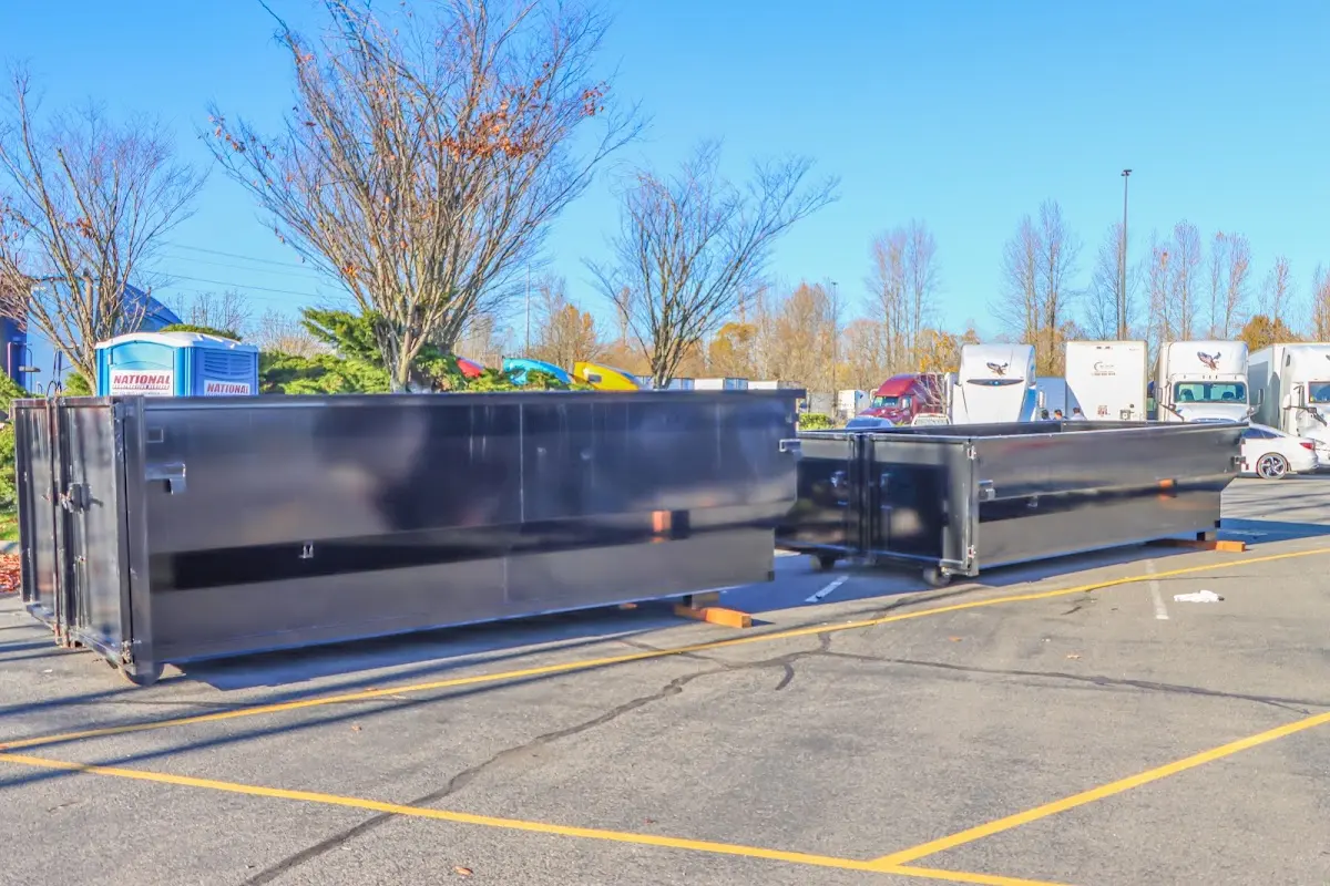 Professional dumpster rental service with roll-off container on residential driveway in Goodlettsville